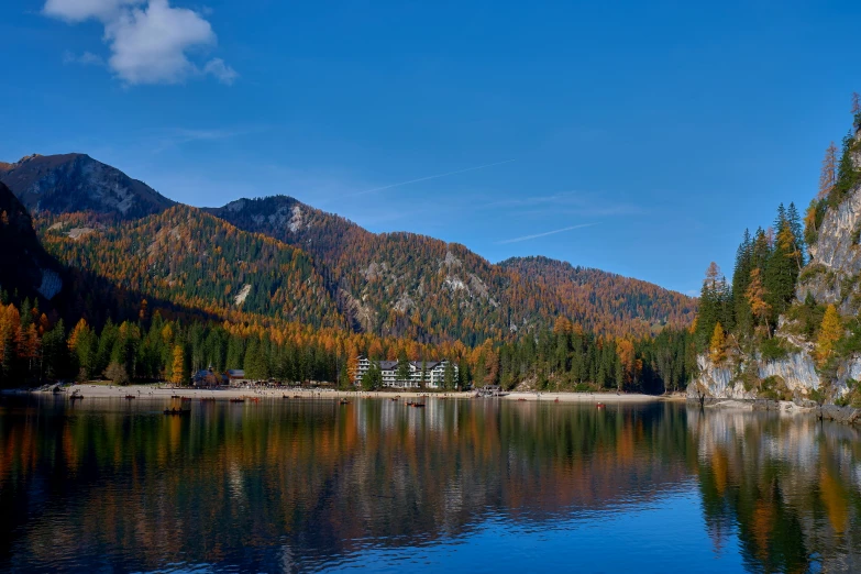 a lake with trees around it on a sunny day