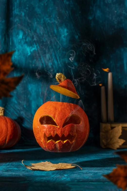 a lighted pumpkin sitting on top of a blue table