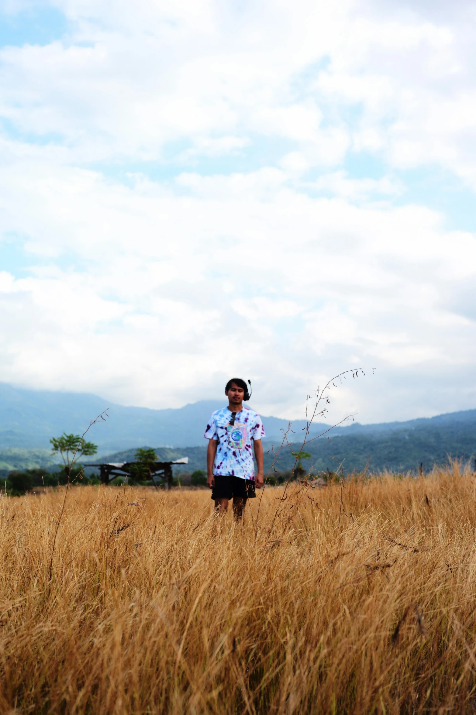 a woman standing on top of a brown field