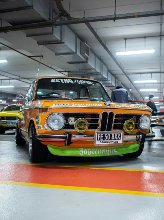 there is an orange bmw car in the building