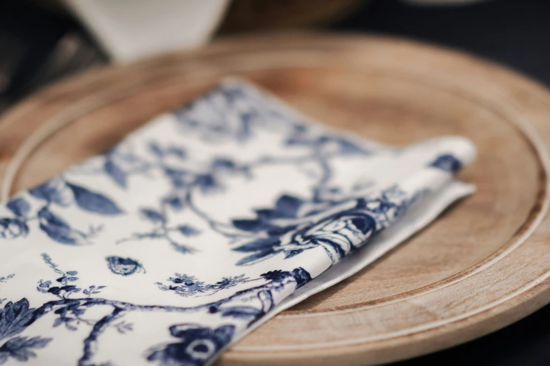 a white and blue napkin on top of a plate