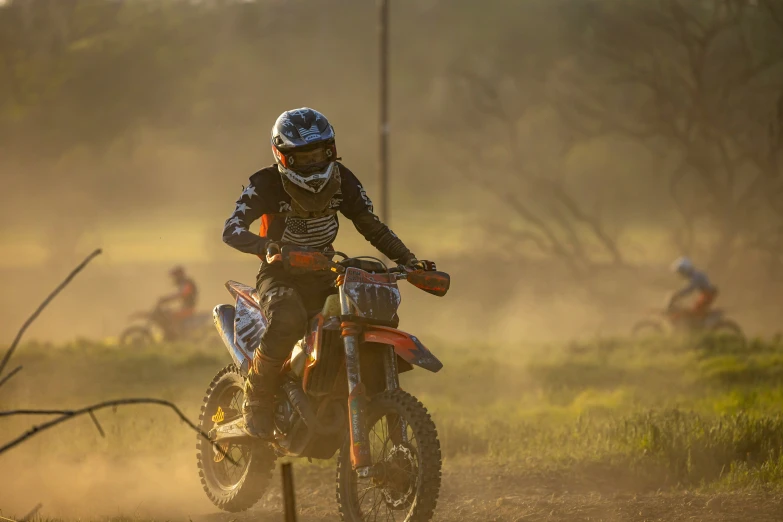 a dirt bike rider wearing a racing uniform riding his dirt bike