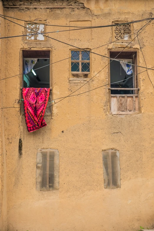a po of a red and pink tarp hanging on a wall