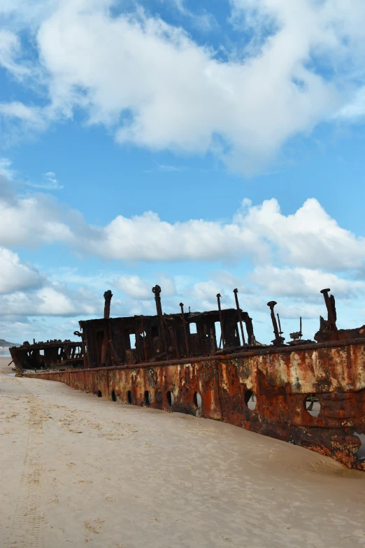 a ship that has been rusted and sitting in the sand