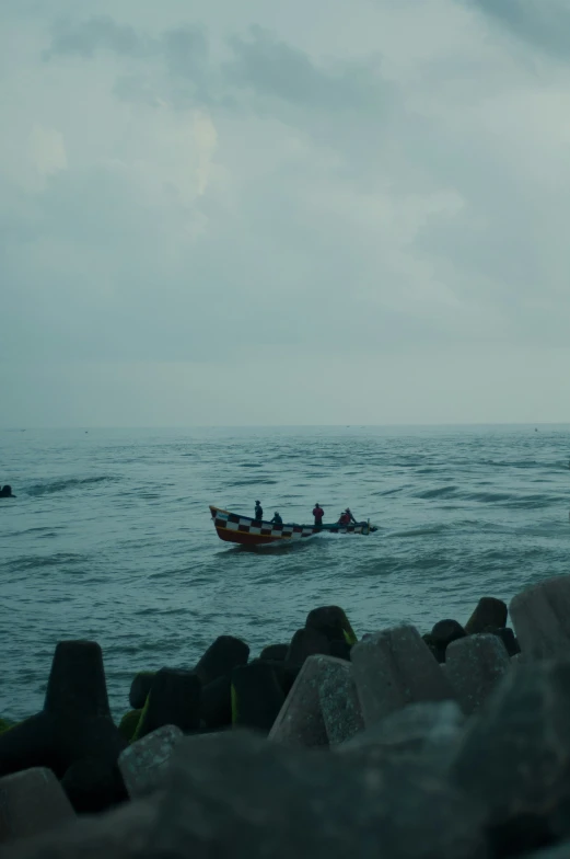 a small boat with people rowing in the water