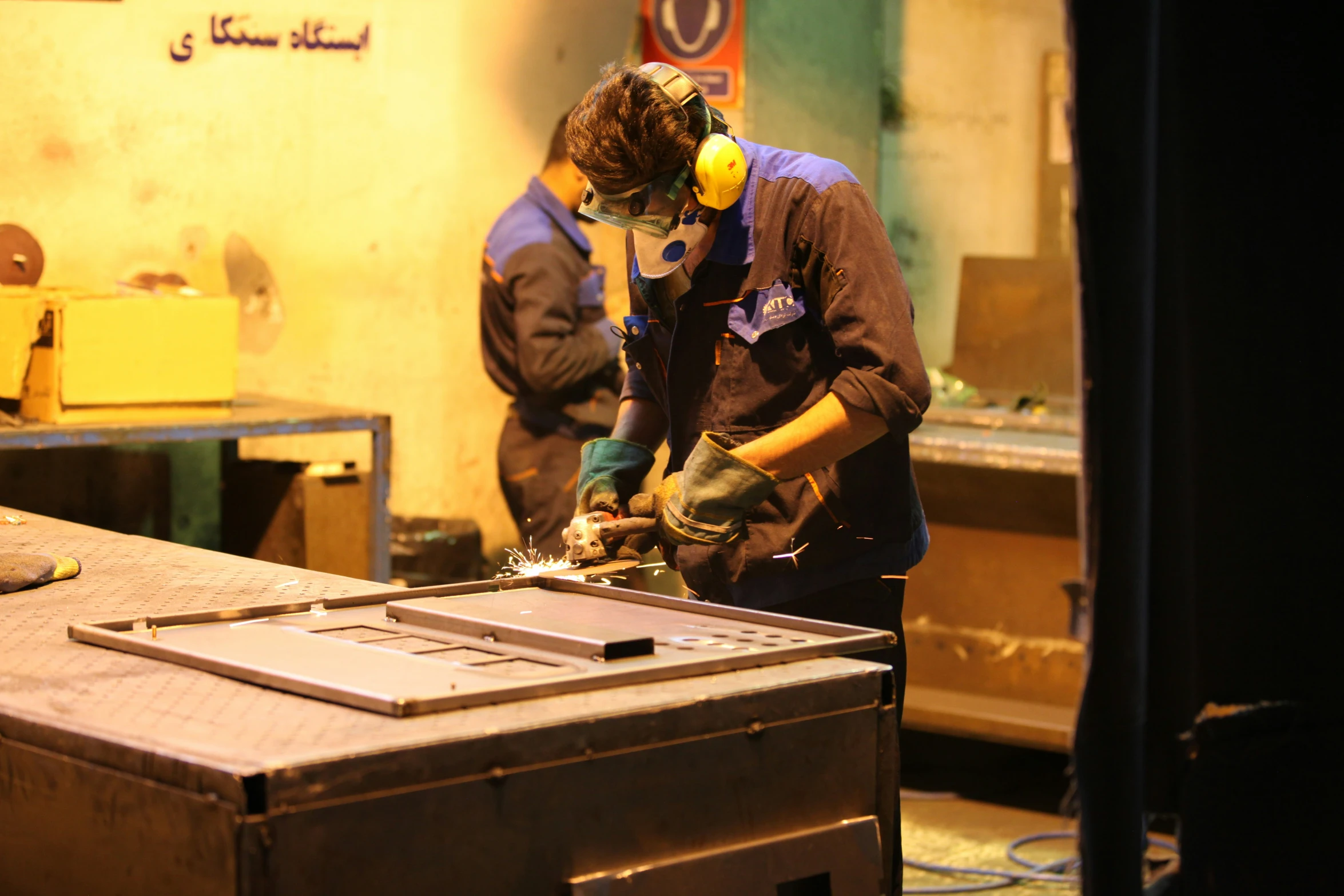 two men in an assembly line making soing with machines