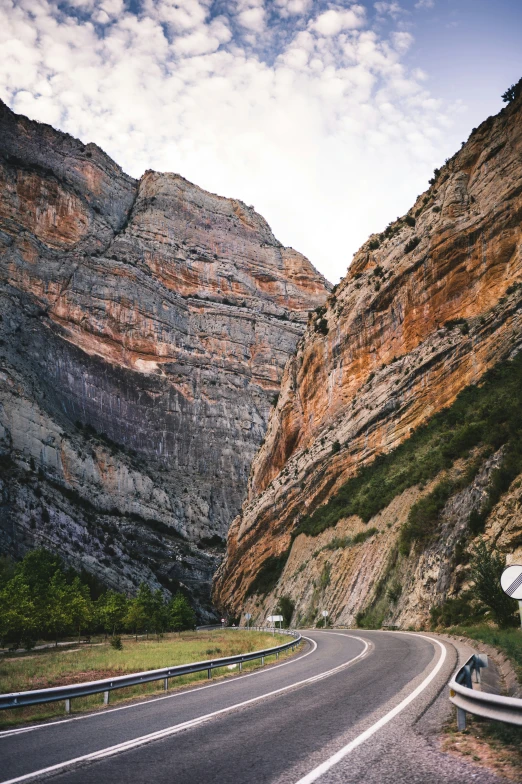 a road is in front of a hill side