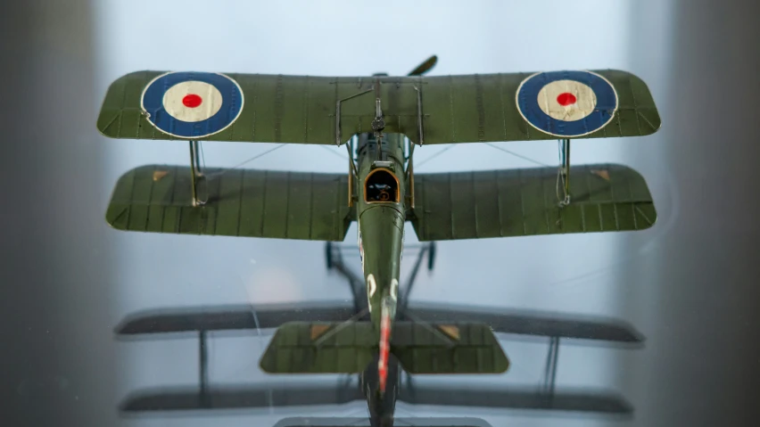 an old fashioned airplane with a flag on the side