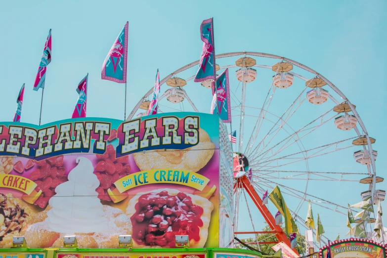 several carnival rides and flags in the sky