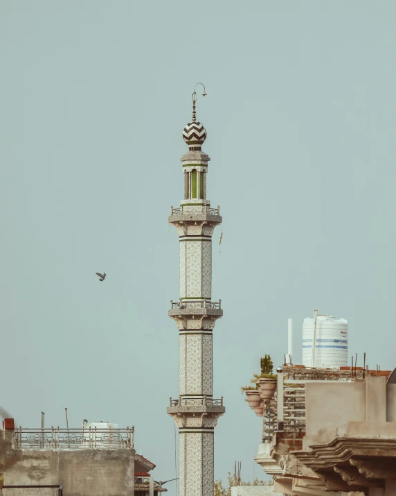 an oriental looking clock tower surrounded by other tall buildings