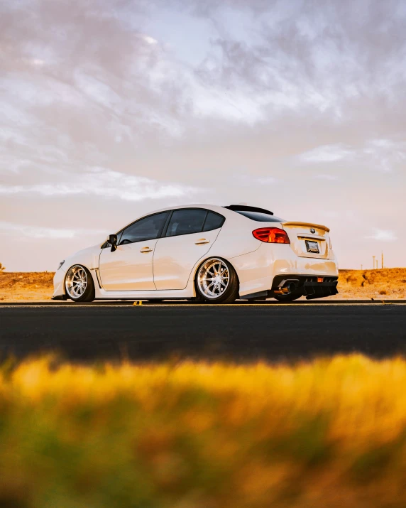 a white car parked on the side of a road