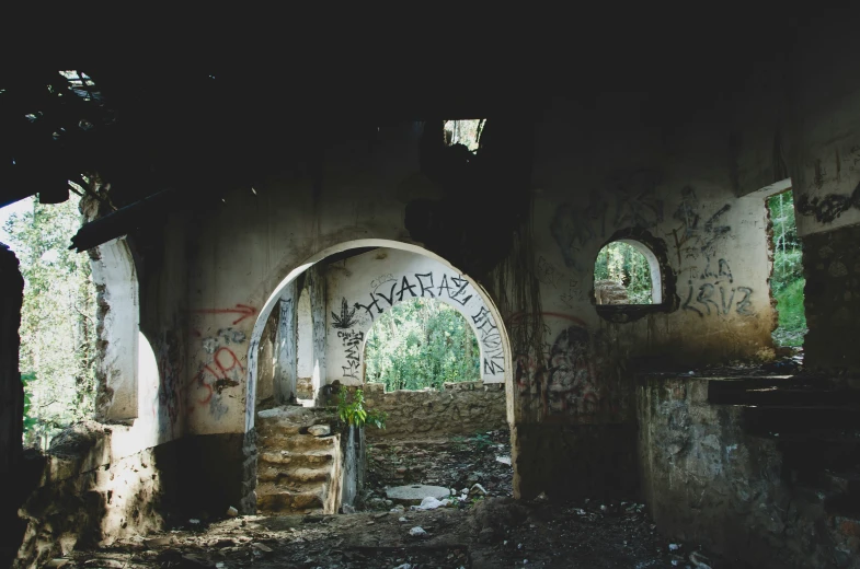 a wall with a doorway on the side and graffiti on it