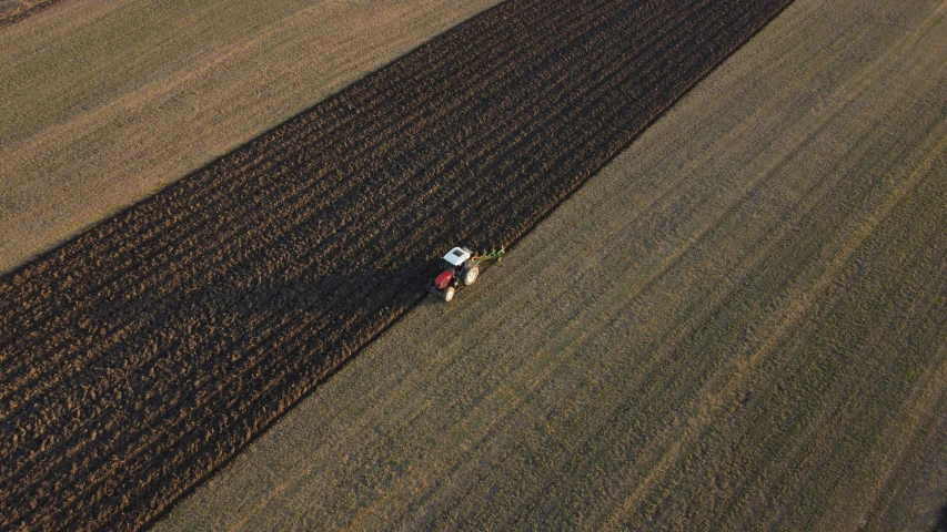 a large field with some people working in it