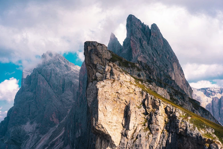 a rock cliff with large mountains in the distance