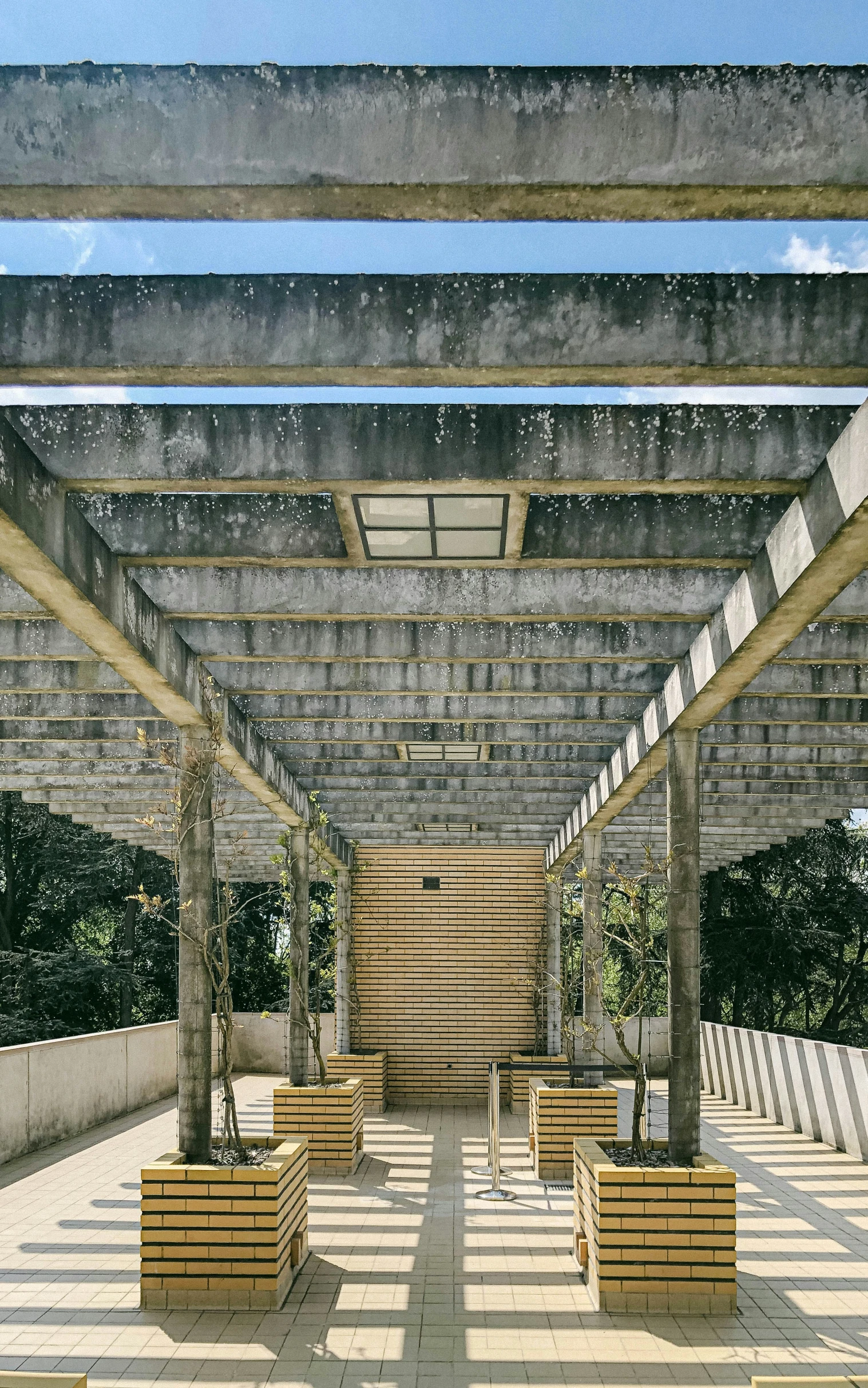 a large stone covered patio with benches and plants