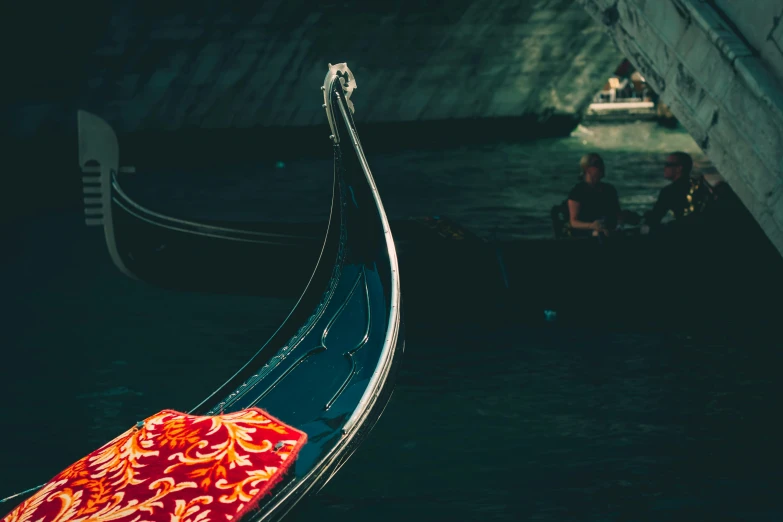 two men riding down a long boat in the water