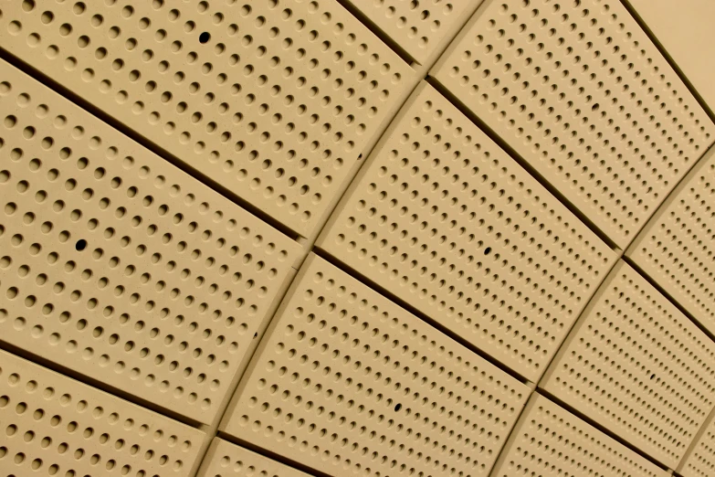 the wall is brown and has perforated holes