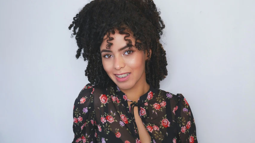 woman with her hair in top knoting standing