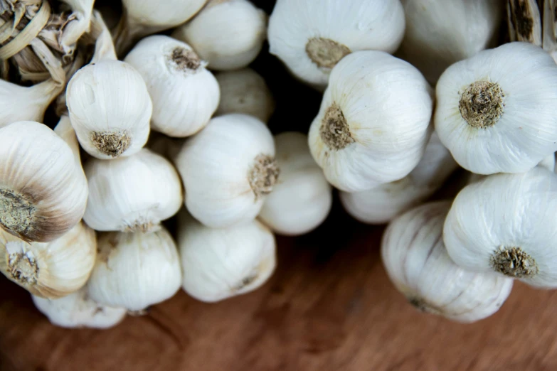 garlic on a  board, some have very little growth