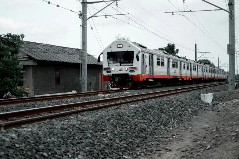 a train traveling down the tracks near buildings