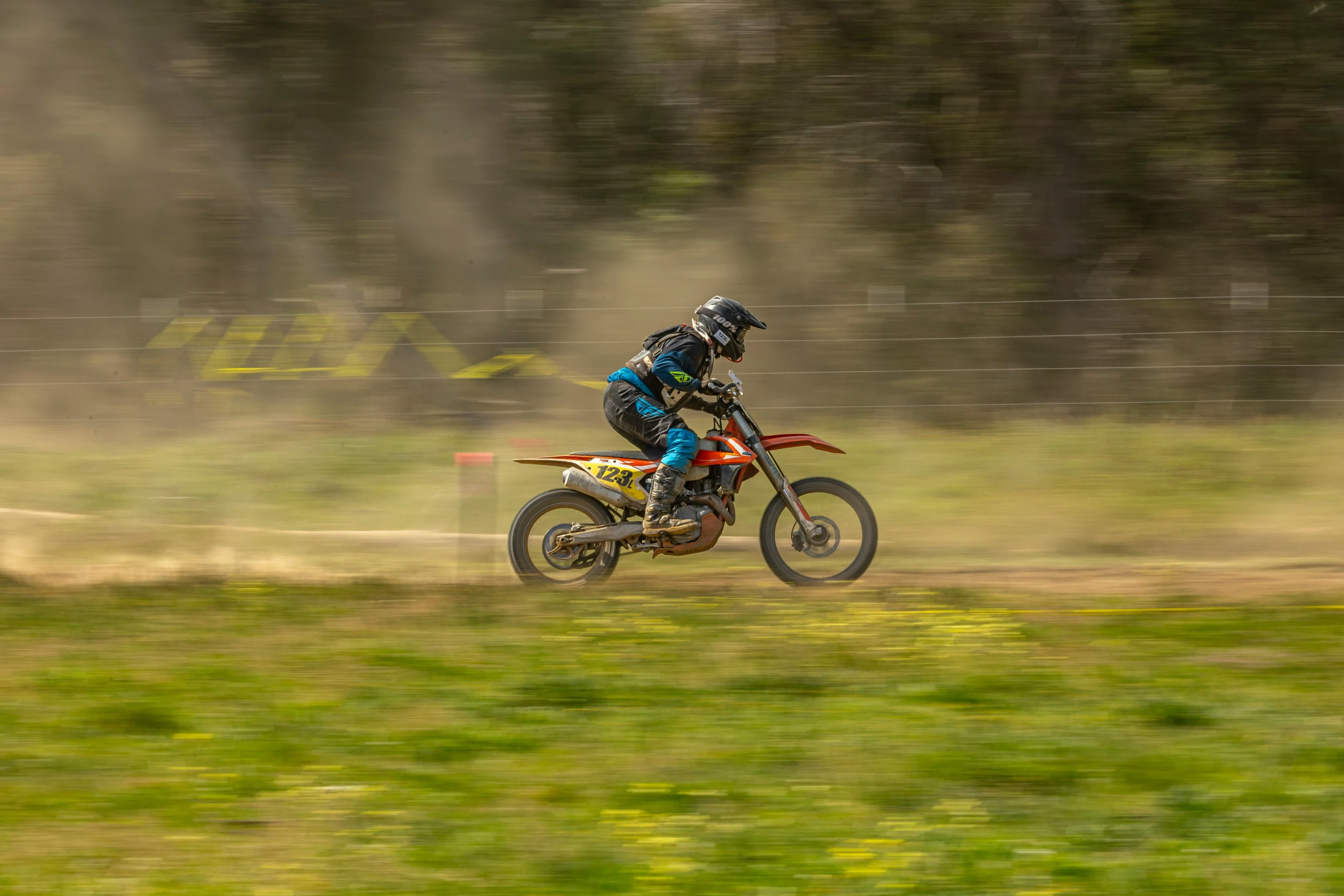 person on motor bike taking a turn on the dirt track