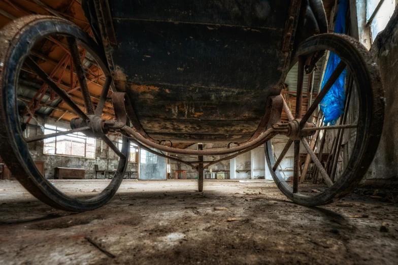 a rustic wagon sits in an abandoned building