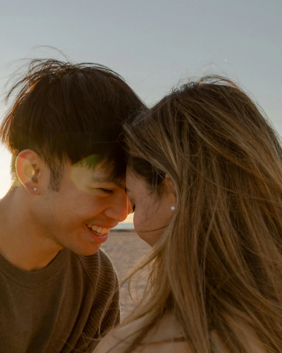 the young man is kissing his girlfriend in the desert