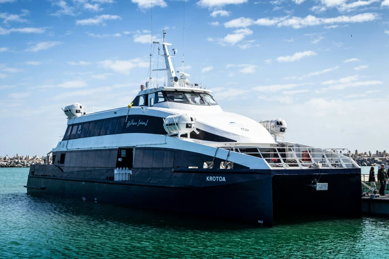 a yacht is docked near a dock in the ocean