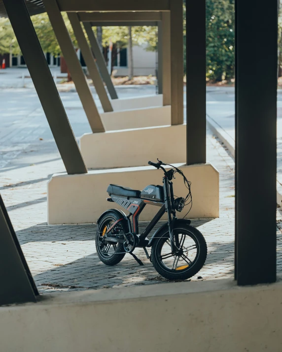 the black motorcycle sits alone near the steps