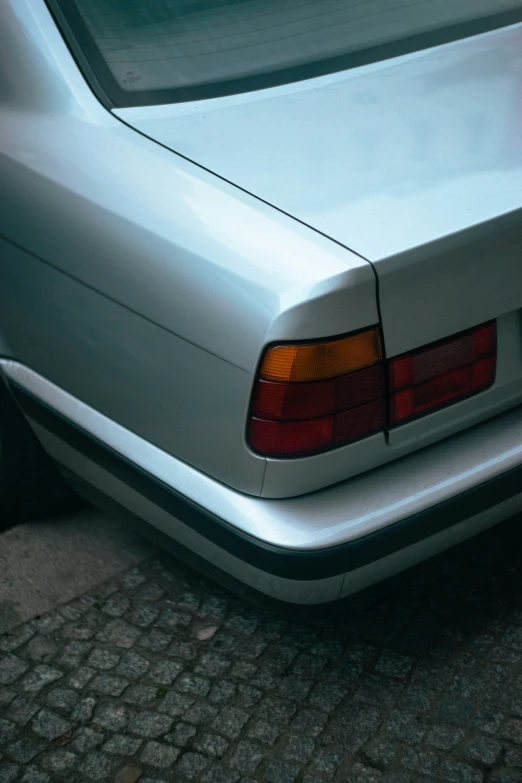 the taillights and hood of a silver car