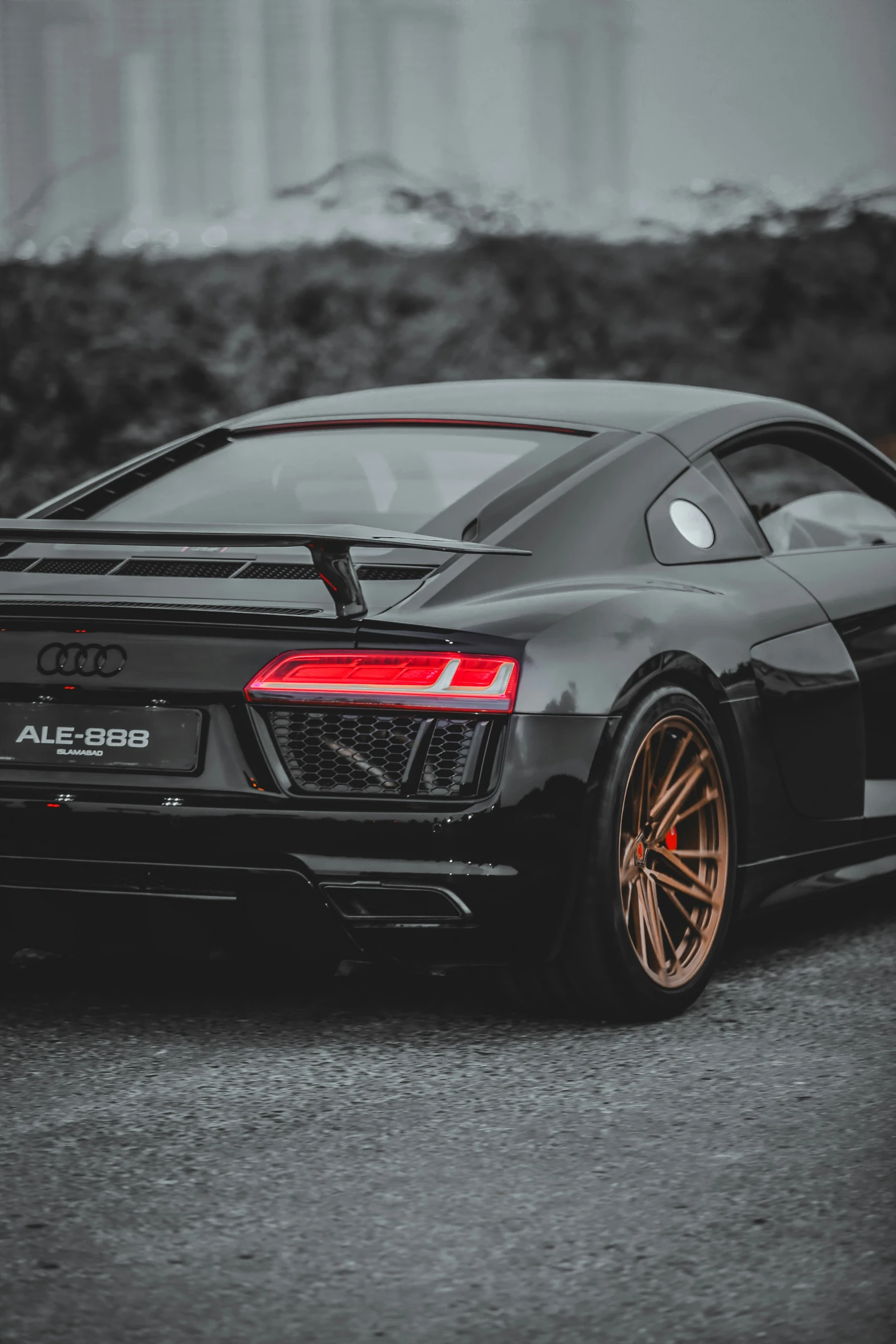 a black sports car parked next to a building