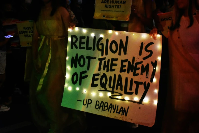 a sign saying religion is not the enemy of equality