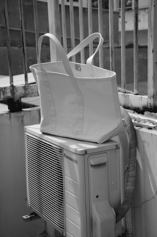 a white carrier sitting on top of a heater next to a building