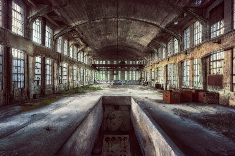 old abandoned building with lots of windows and lots of trash