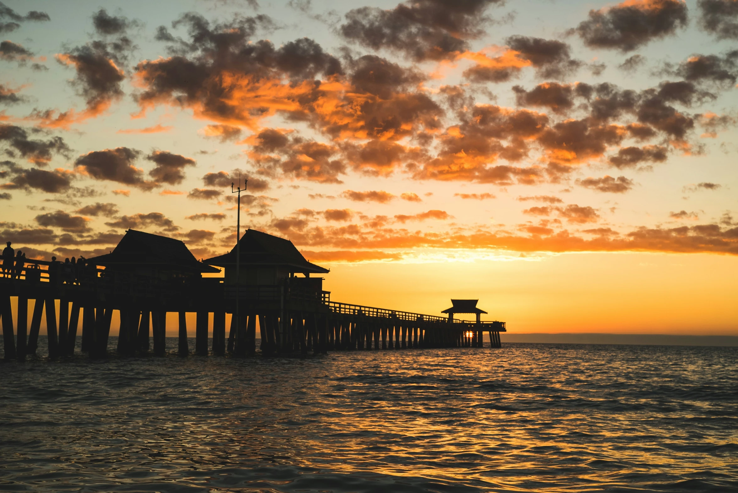 the sunset reflects on the water in the ocean