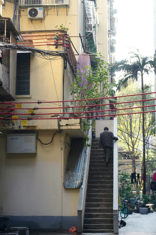 a staircase going down to a building in an asian town