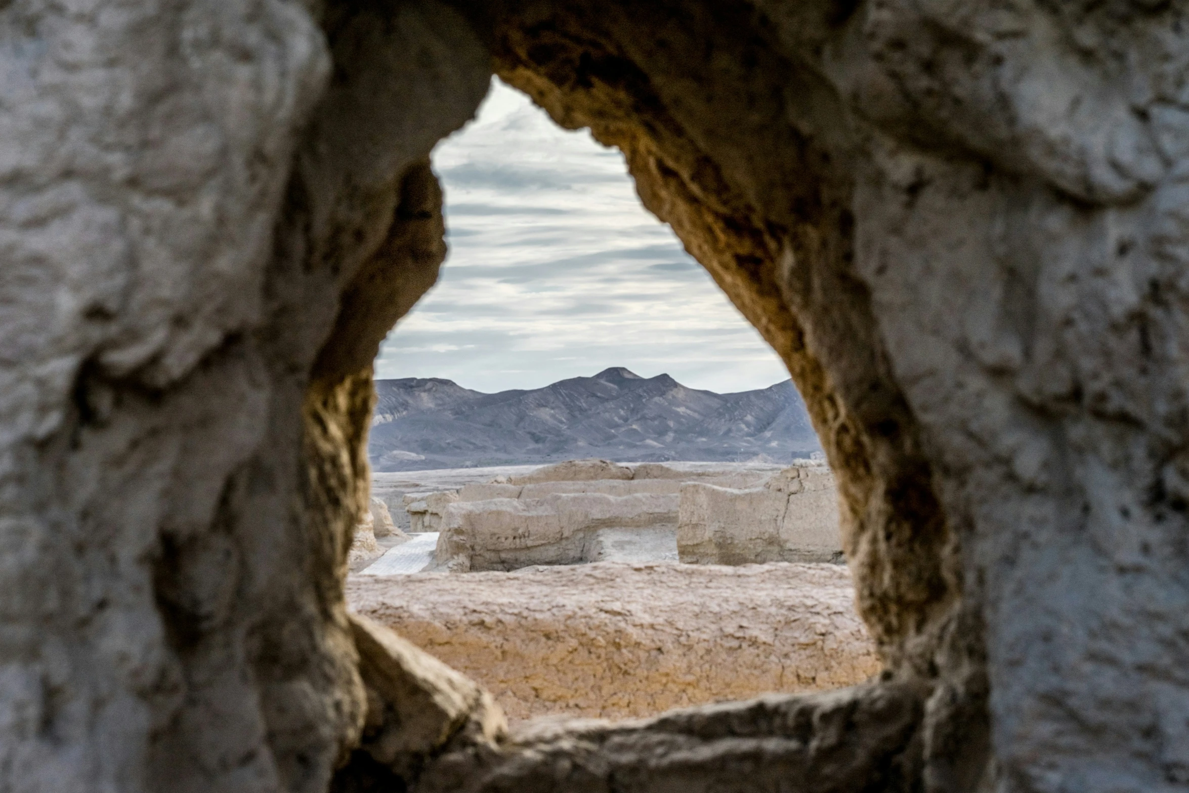 the view from within an arch looking out at the landscape