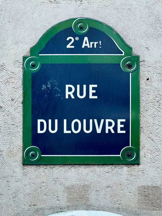 an image of blue and green street sign in french
