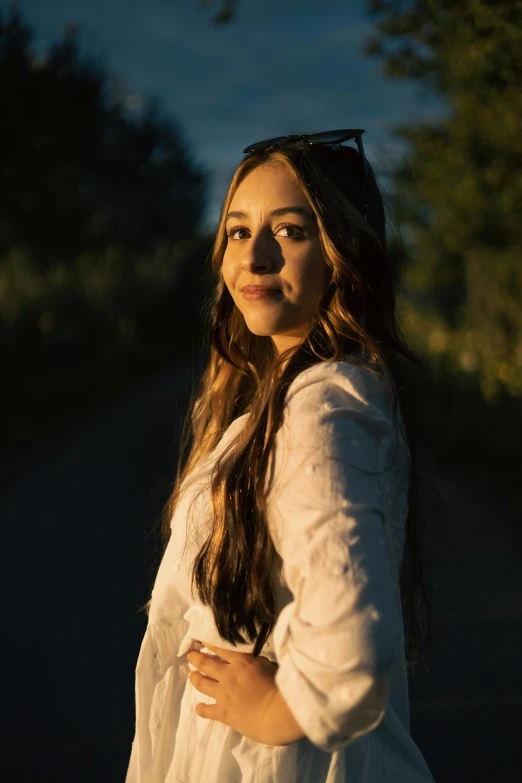 a beautiful young woman posing for a po