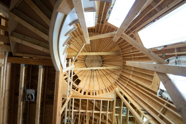 inside view of spiral wooden roof structure in residential area