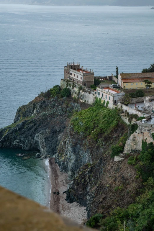 the village is perched on a rocky cliff next to the water