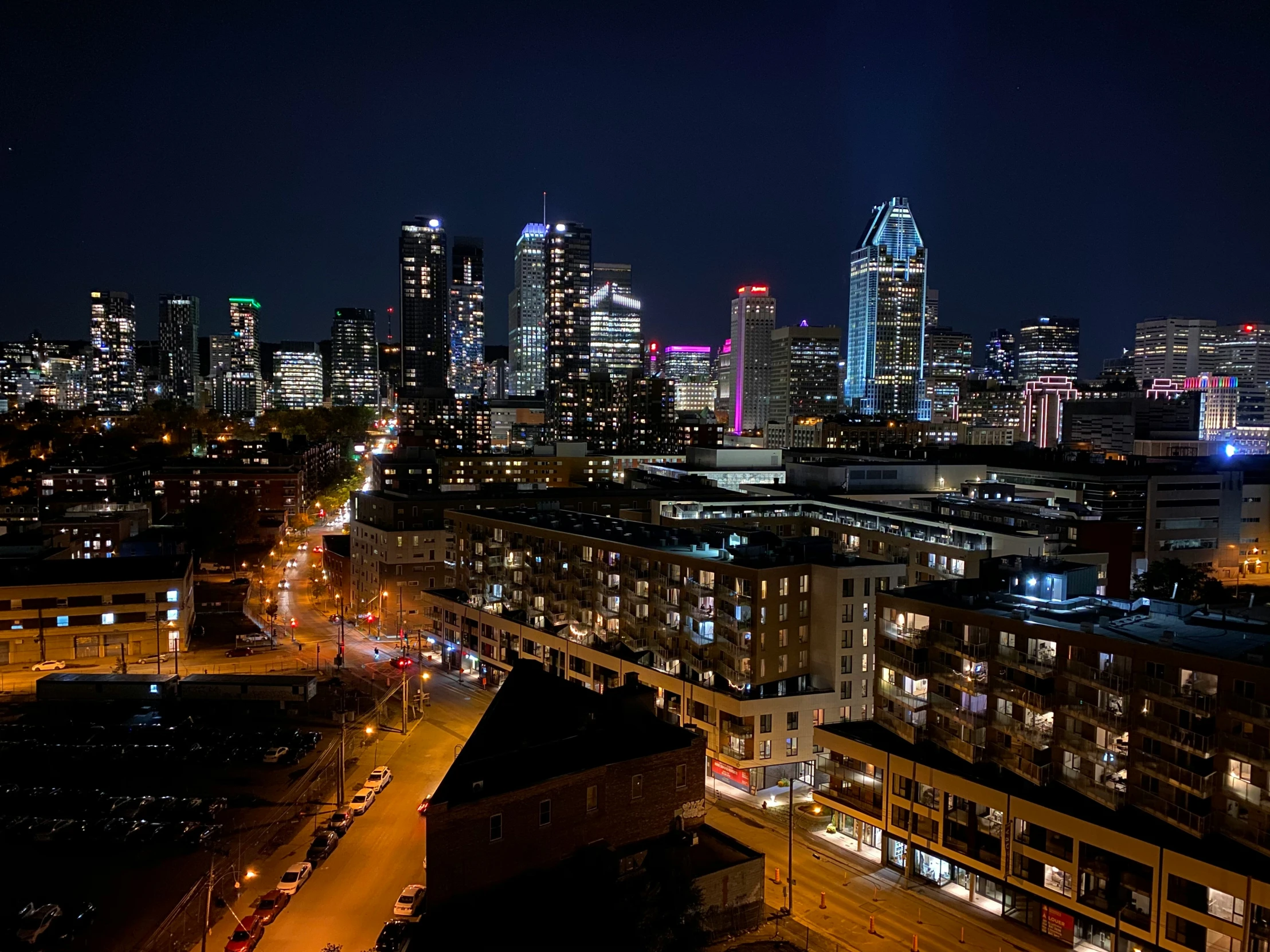 a view of a city at night with bright lights