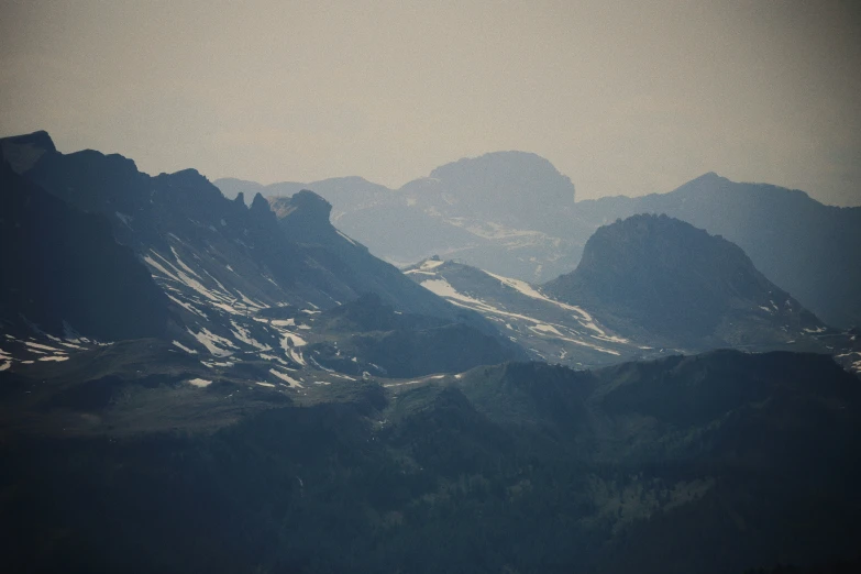 a bunch of mountains covered in snow and trees