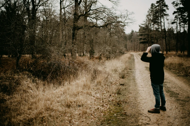 person walking in the middle of an empty road