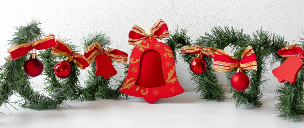 a red candle is in a row of christmas decorations