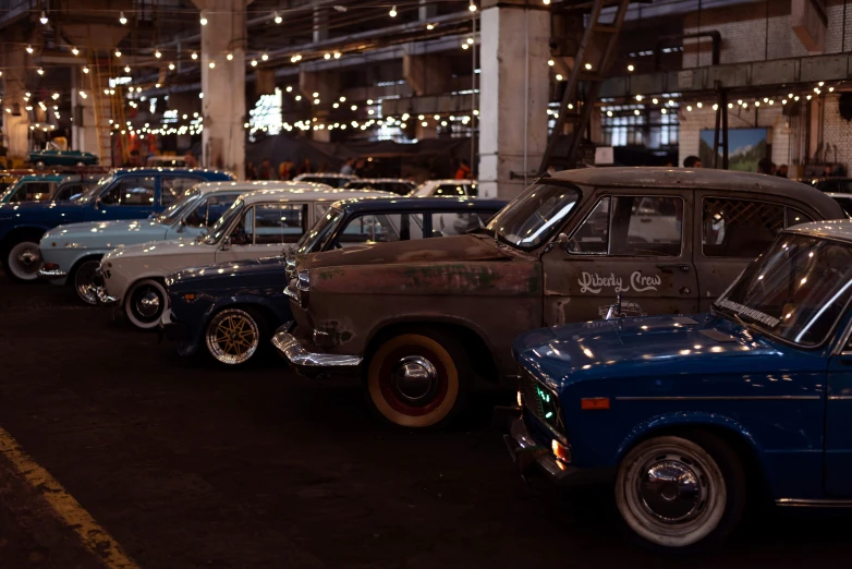 old style cars lined up in the dark