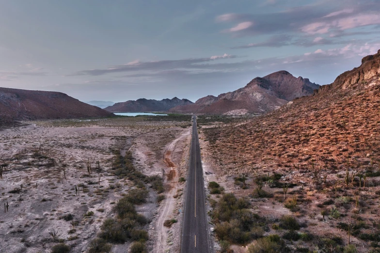 an empty road in the middle of some desert