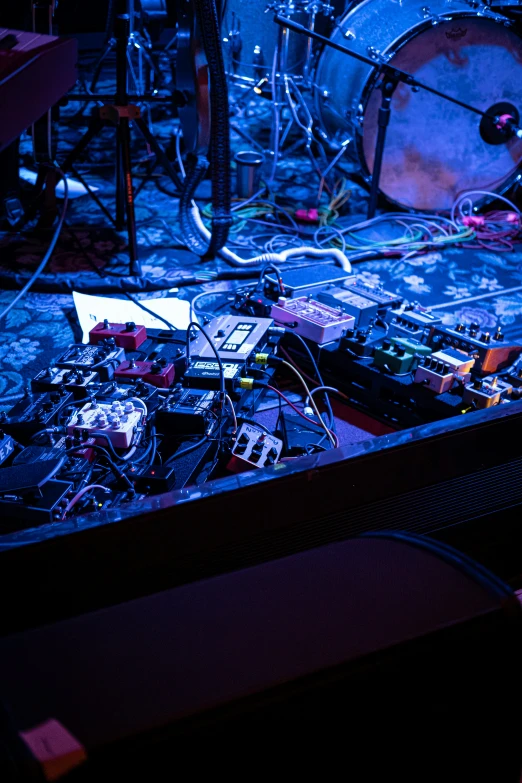 instruments and electronics on the floor in front of a speaker