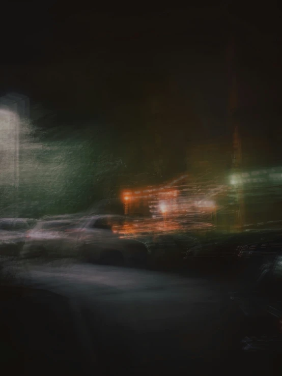 the night scene of cars driving down a street