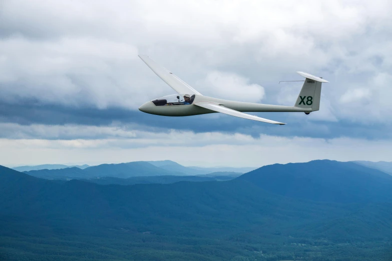 an airplane flies over some mountains and clouds